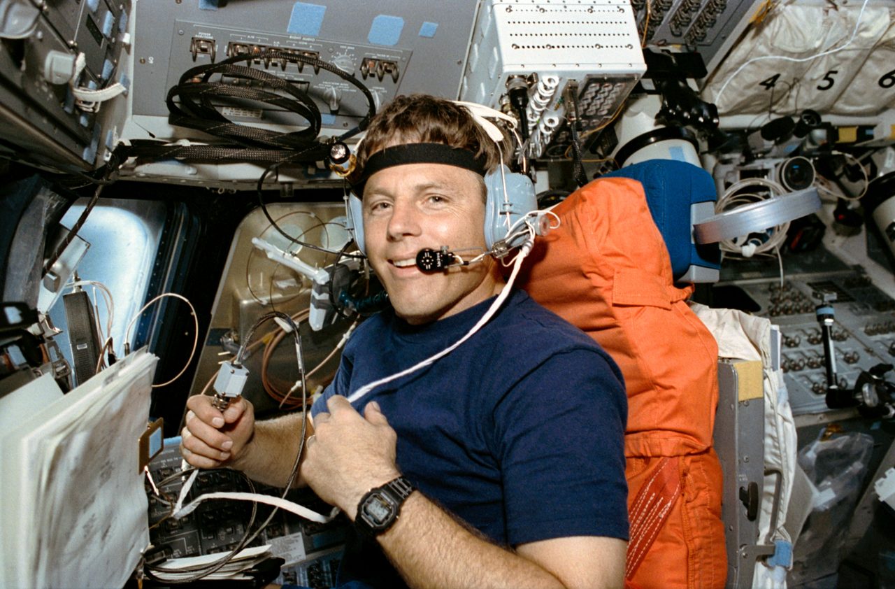 Pilot Oswald operates SAREX equipment on Discovery's forward flight deck during STS-56 mission.