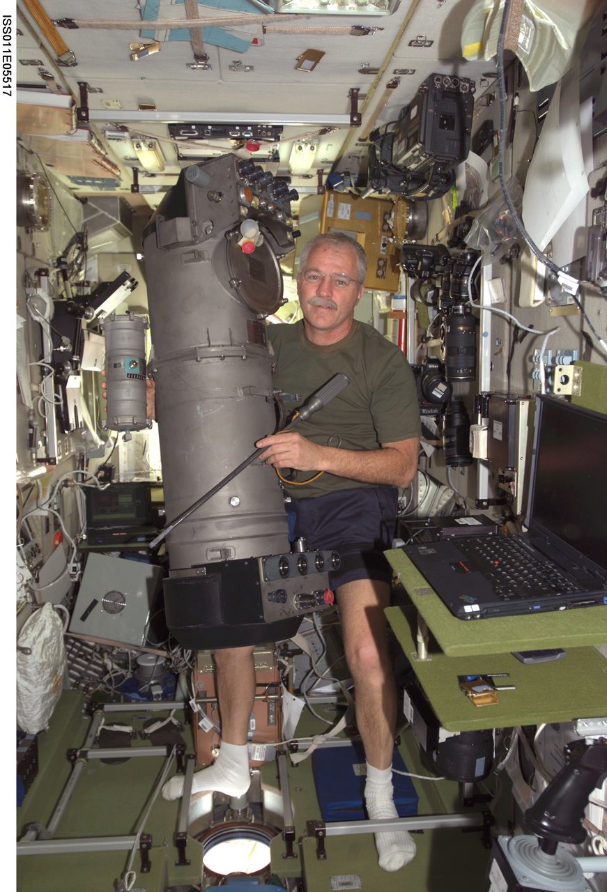 Astronaut Phillips performs repairs on the Elektron oxygen generator aboard the International Space Station.