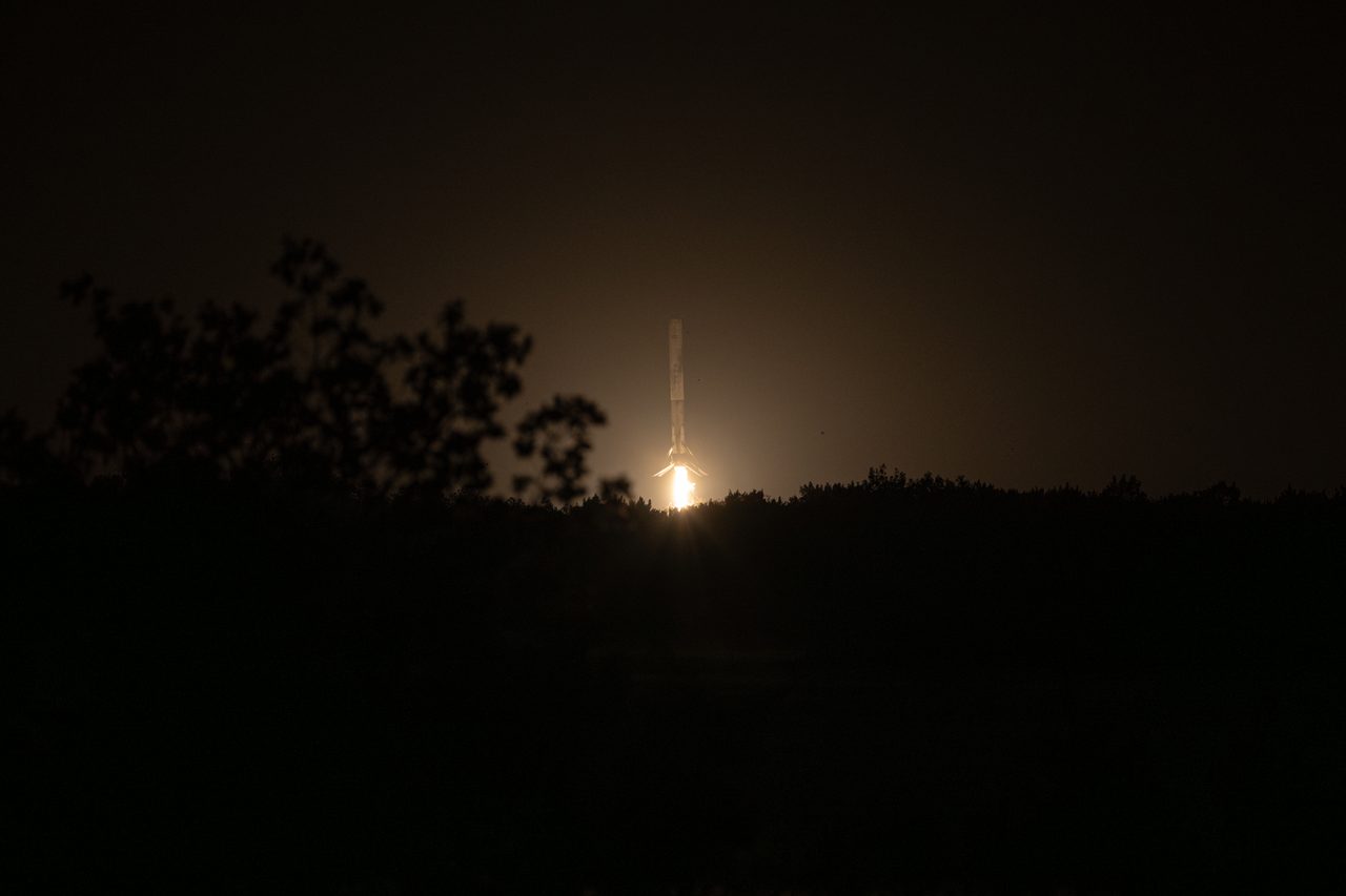 SpaceX Falcon 9 rocket successfully landing on ocean platform after NASA Crew-12 mission launch.
