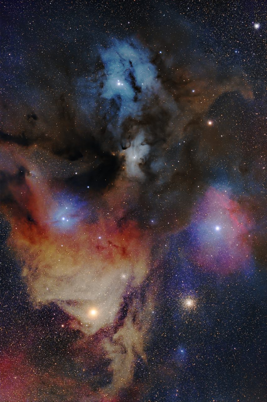 A vibrant astronomical image of Rho Ophiuchi with swirling pink and blue clouds in space.
