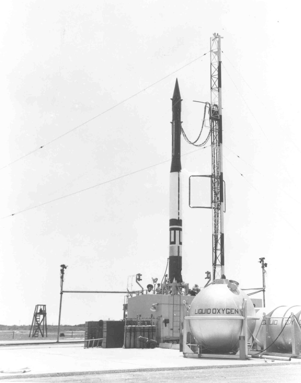 A vintage photograph of a rocket launch at Kennedy Space Center, capturing the moment of liftoff.