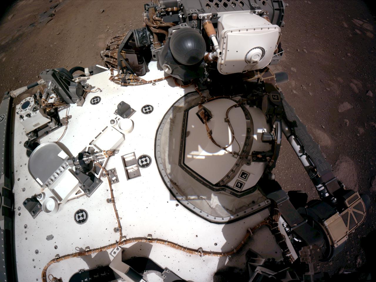View from Perseverance's Navcams showing rover deck with PIXL instrument on stowed robotic arm.