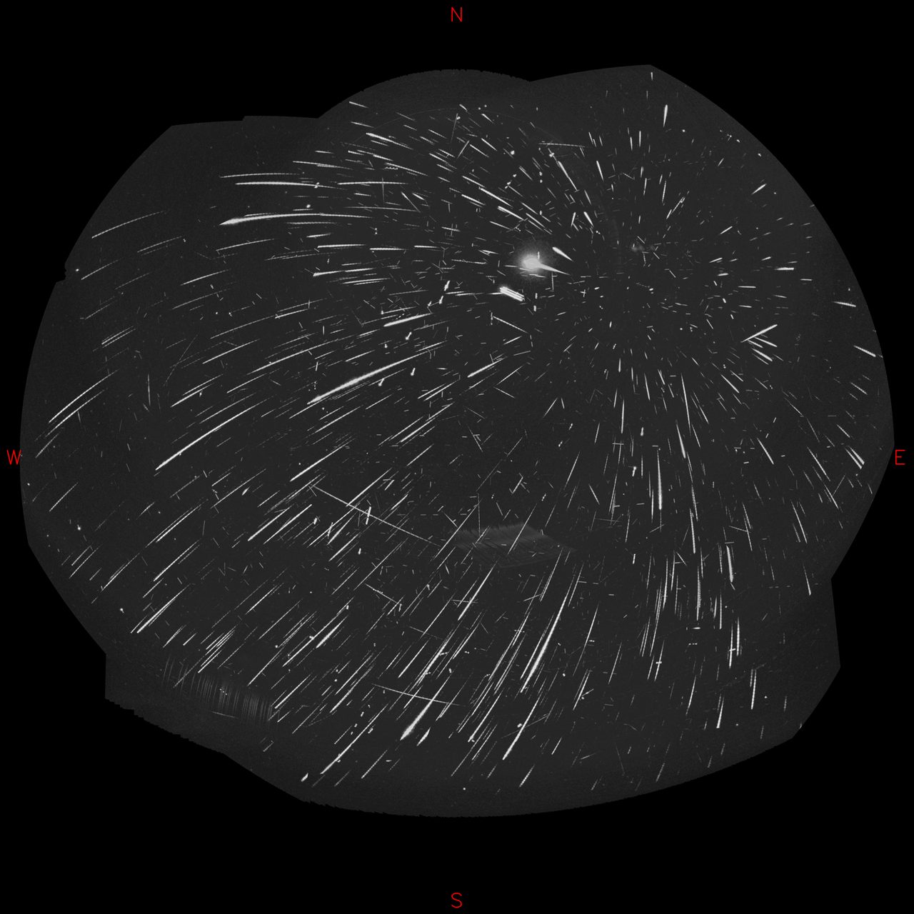 A night sky filled with bright Perseid meteors streaking across the stars.