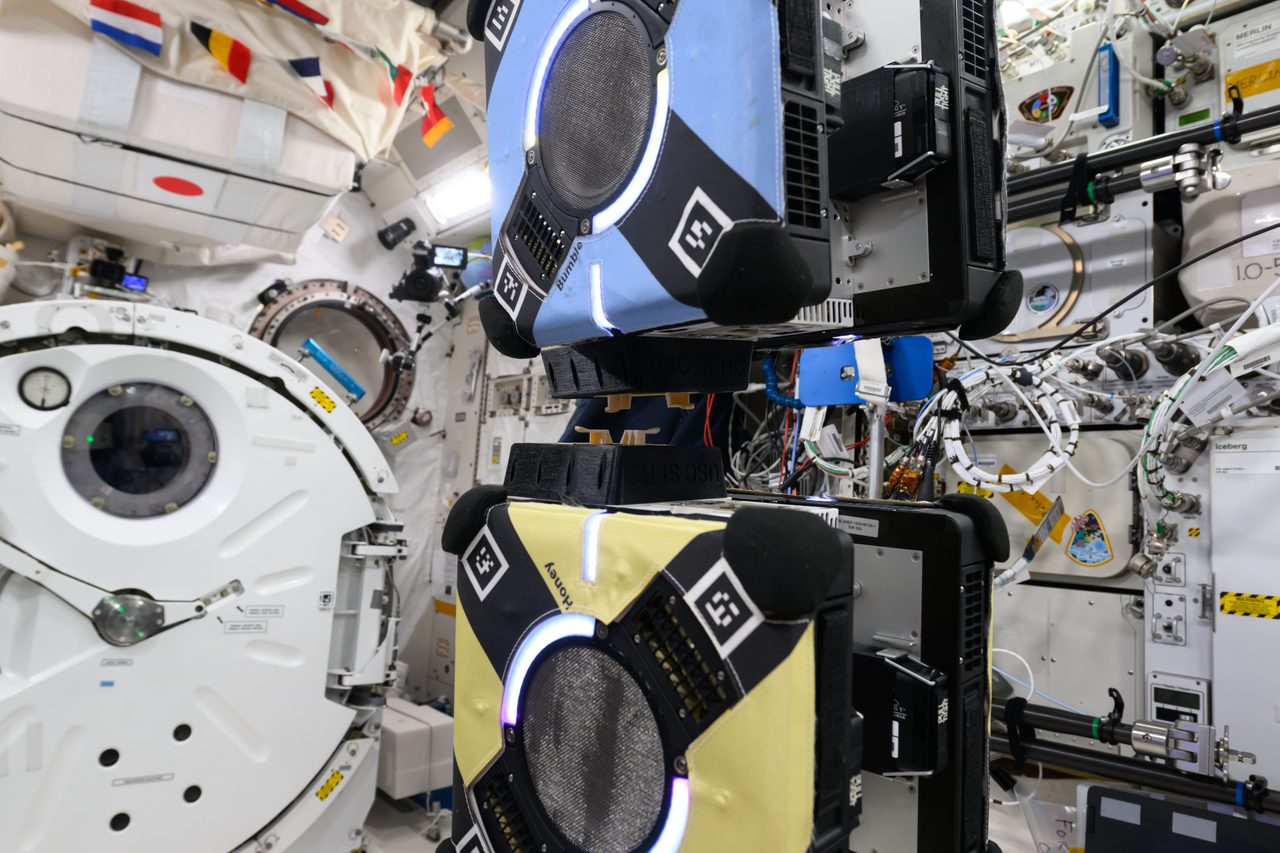 Astronauts aboard the International Space Station capturing Earth from space with camera equipment.