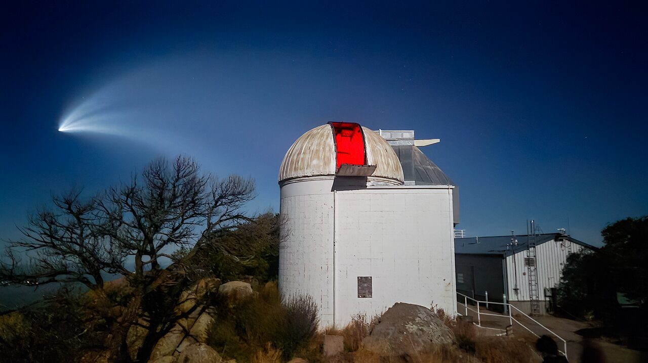 Group of people stargazing with telescopes under a clear night sky at Kitt Peak Observatory.