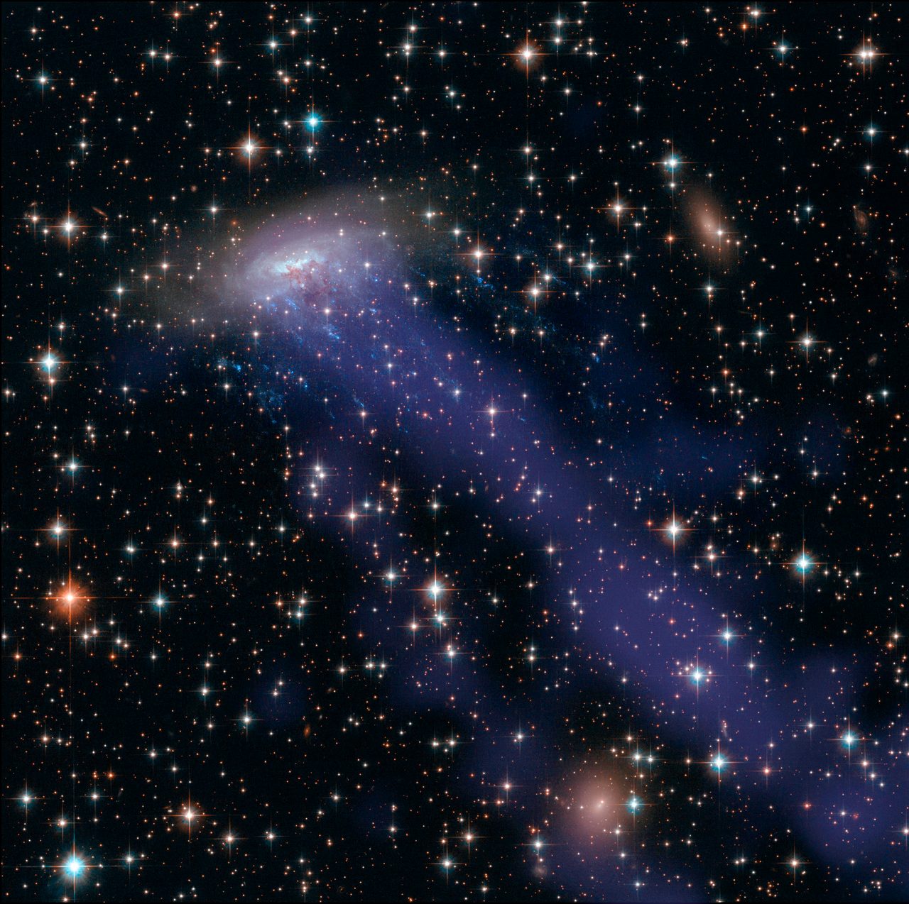 Hubble Space Telescope captures a vibrant, fast-moving galaxy with swirling stars and cosmic dust.