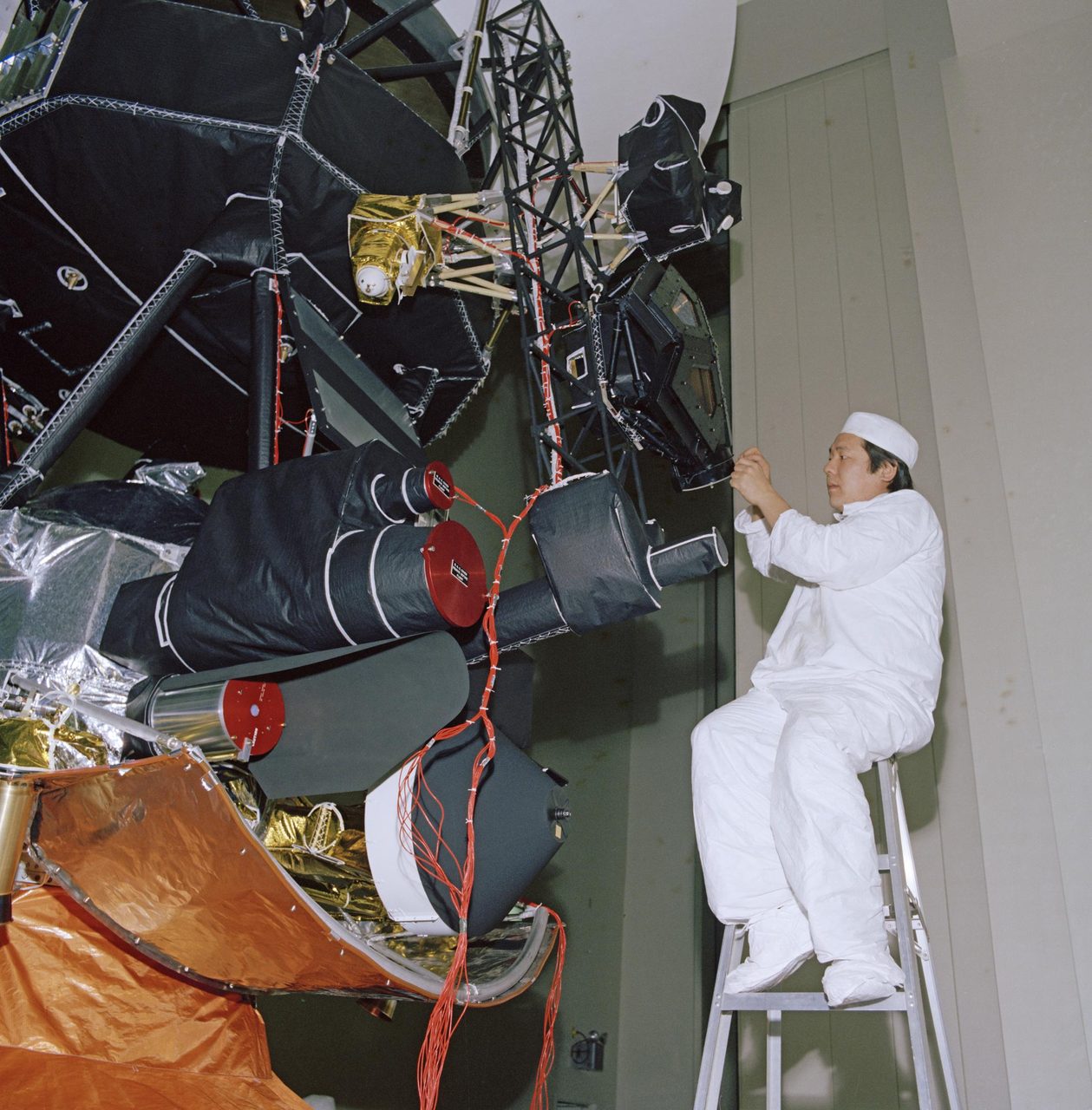 Engineer conducting vibration acoustics and pyro shock testing on NASA's Voyager spacecraft in 1976.
