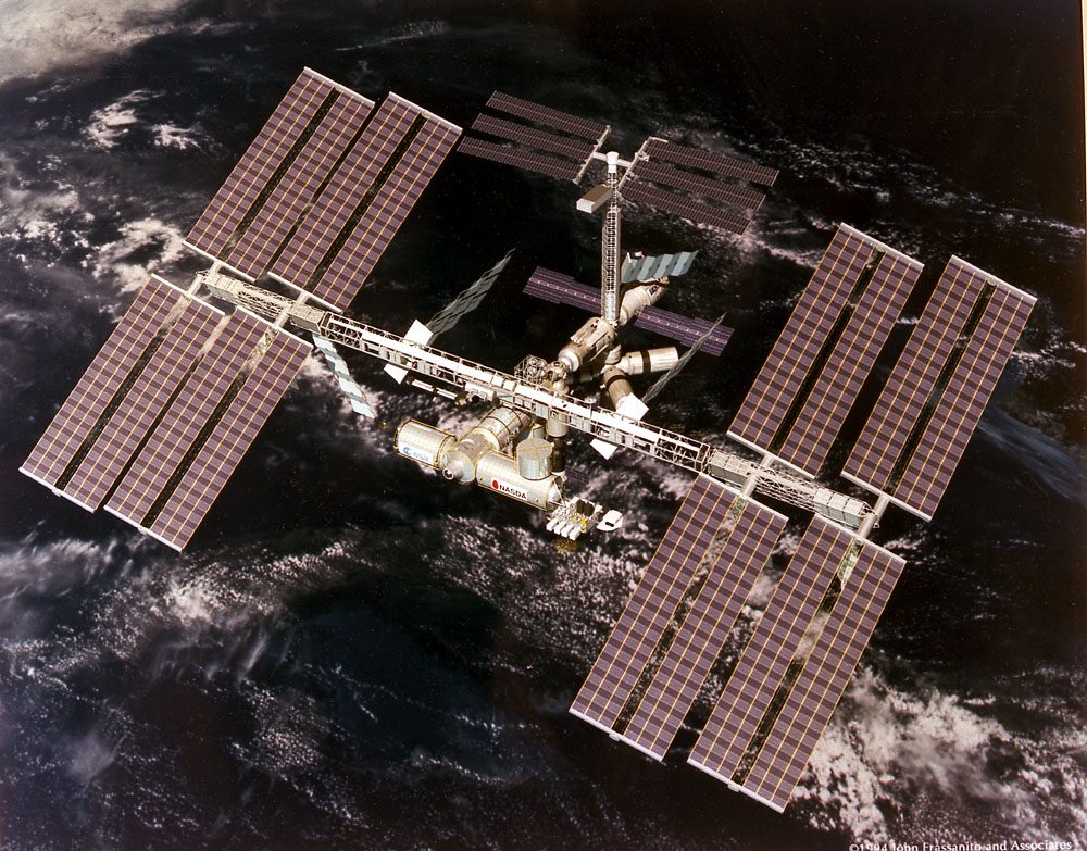 The International Space Station orbiting Earth, showcasing its solar arrays and modules.
