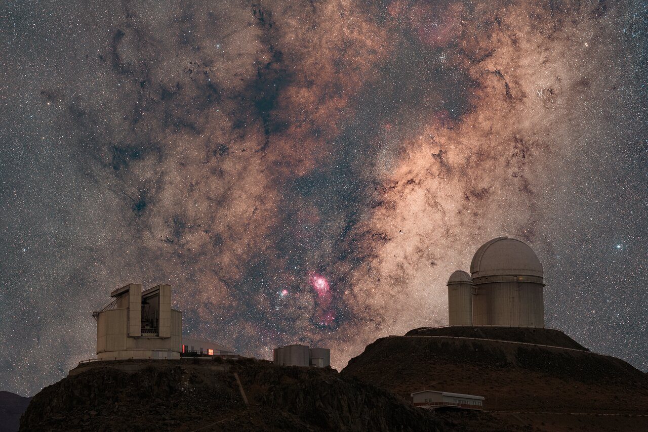 A starry night sky with dark clouds partially obscuring the bright stars.
