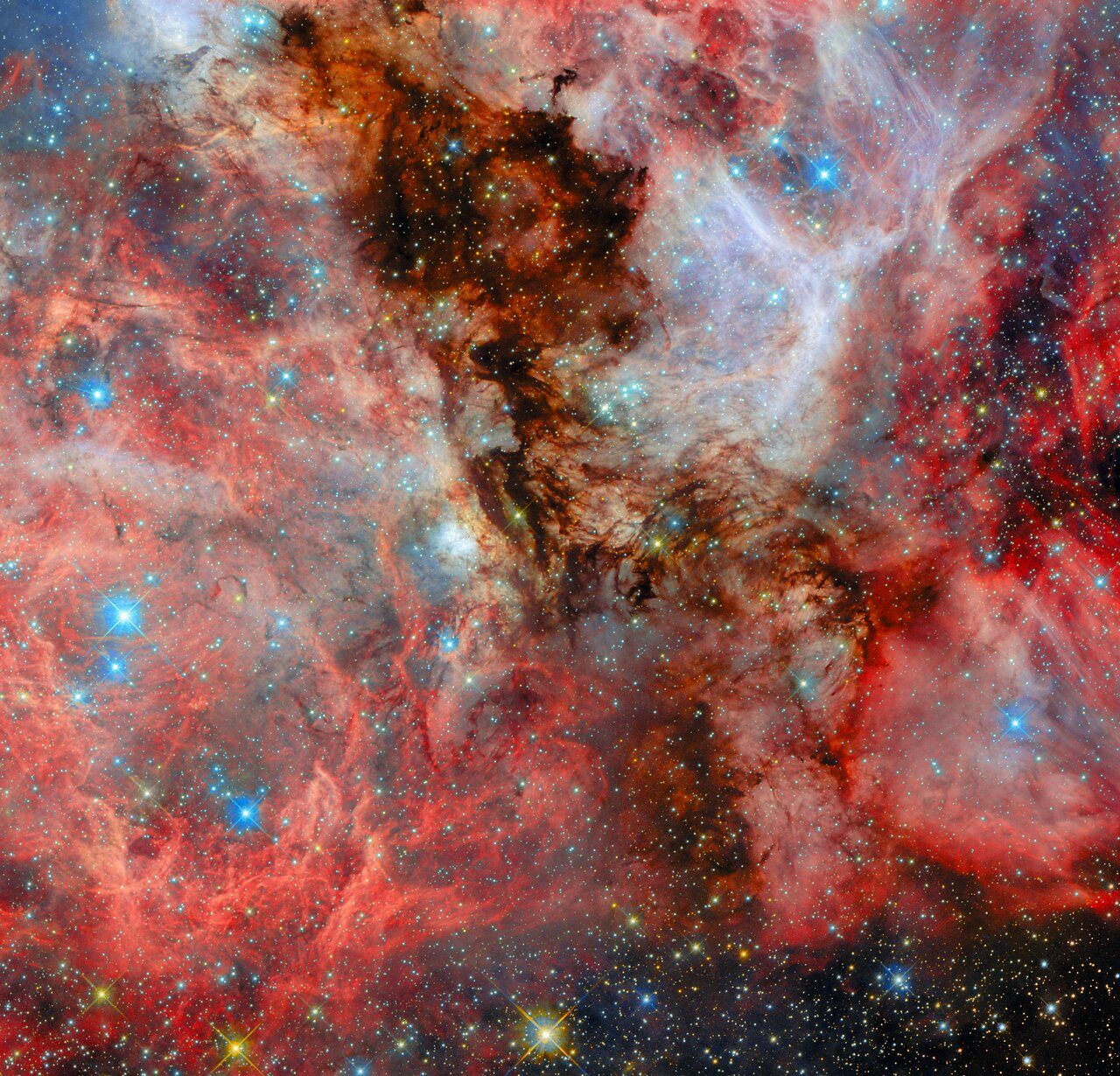 A vibrant cosmic scene showing a nebula with colorful gas clouds and newly formed stars in deep space.