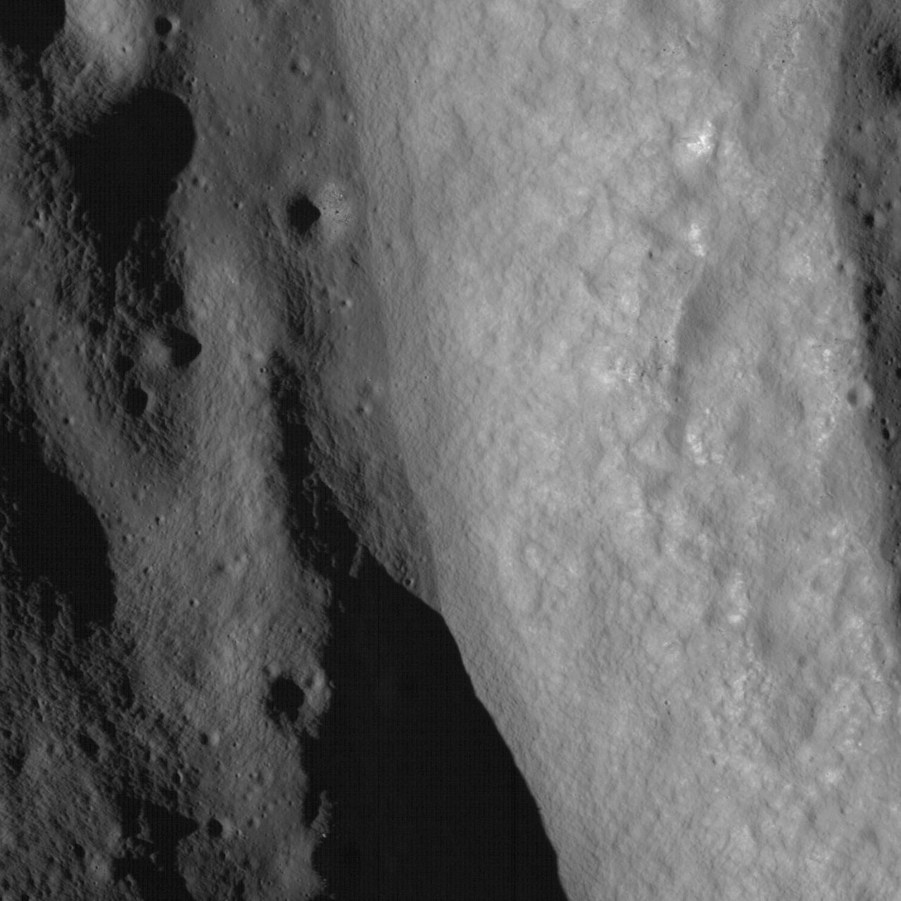 Aerial view of terraced wall formations inside Bürg Crater on the Moon's surface.