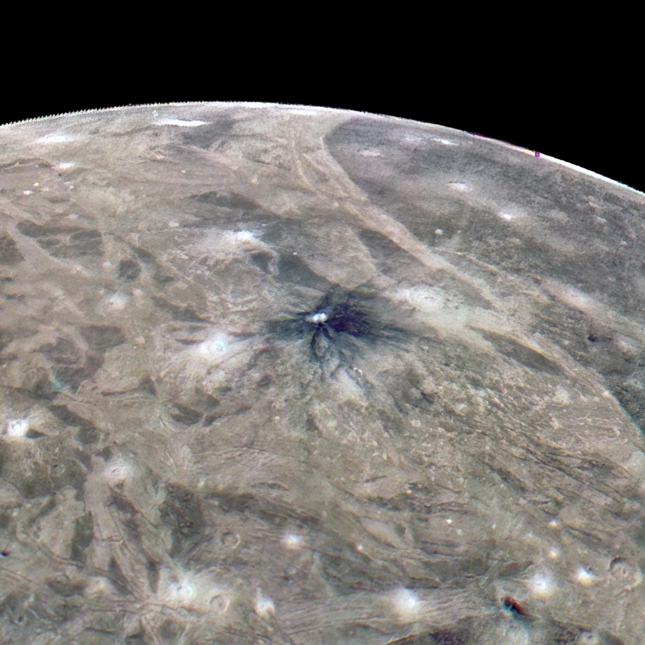 Close-up of a large crater on Ganymede's icy surface, revealing intricate patterns captured by NASA's Juno mission.
