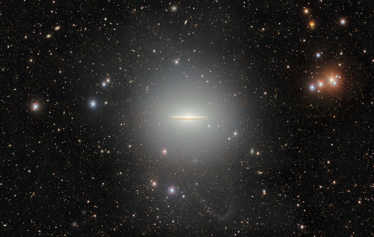 A detailed view of Messier 104, also known as the Sombrero Galaxy, with its bright core and dark dust lane.