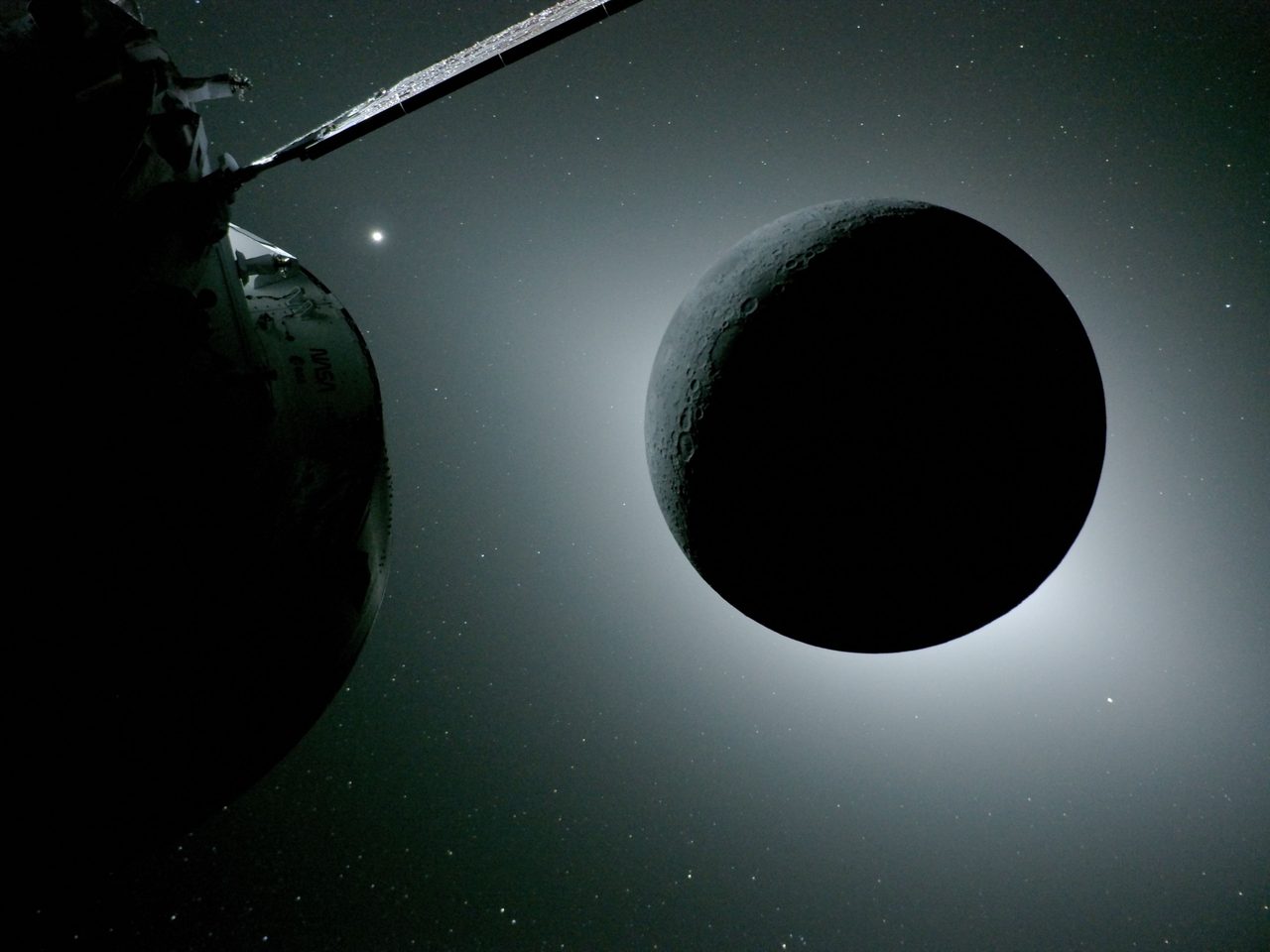 A solar eclipse viewed from space during the Artemis II mission, with the Earth in the background.