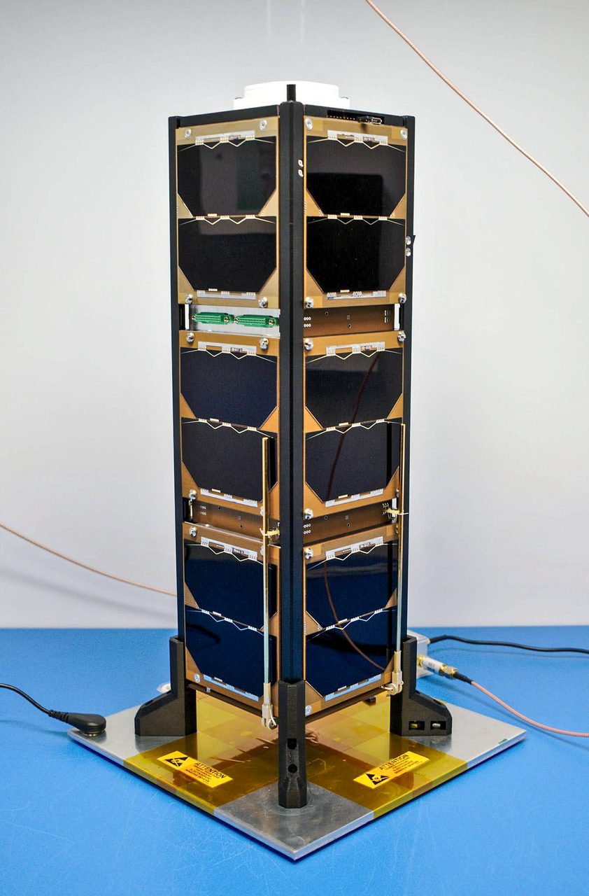 Aerial view of a large, modern spacecraft with solar panels orbiting a distant planet.