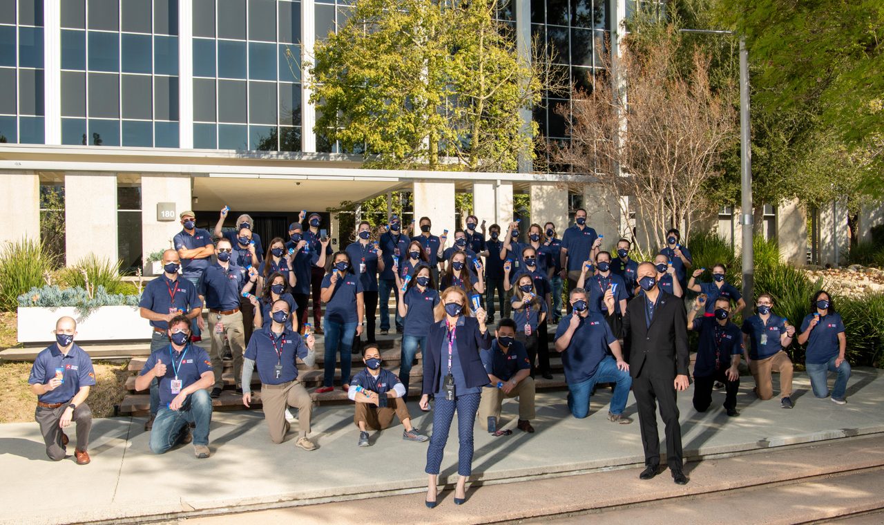 NASA's Mars Perseverance rover team posing with lucky peanuts at Jet Propulsion Laboratory before February 2021 landing.