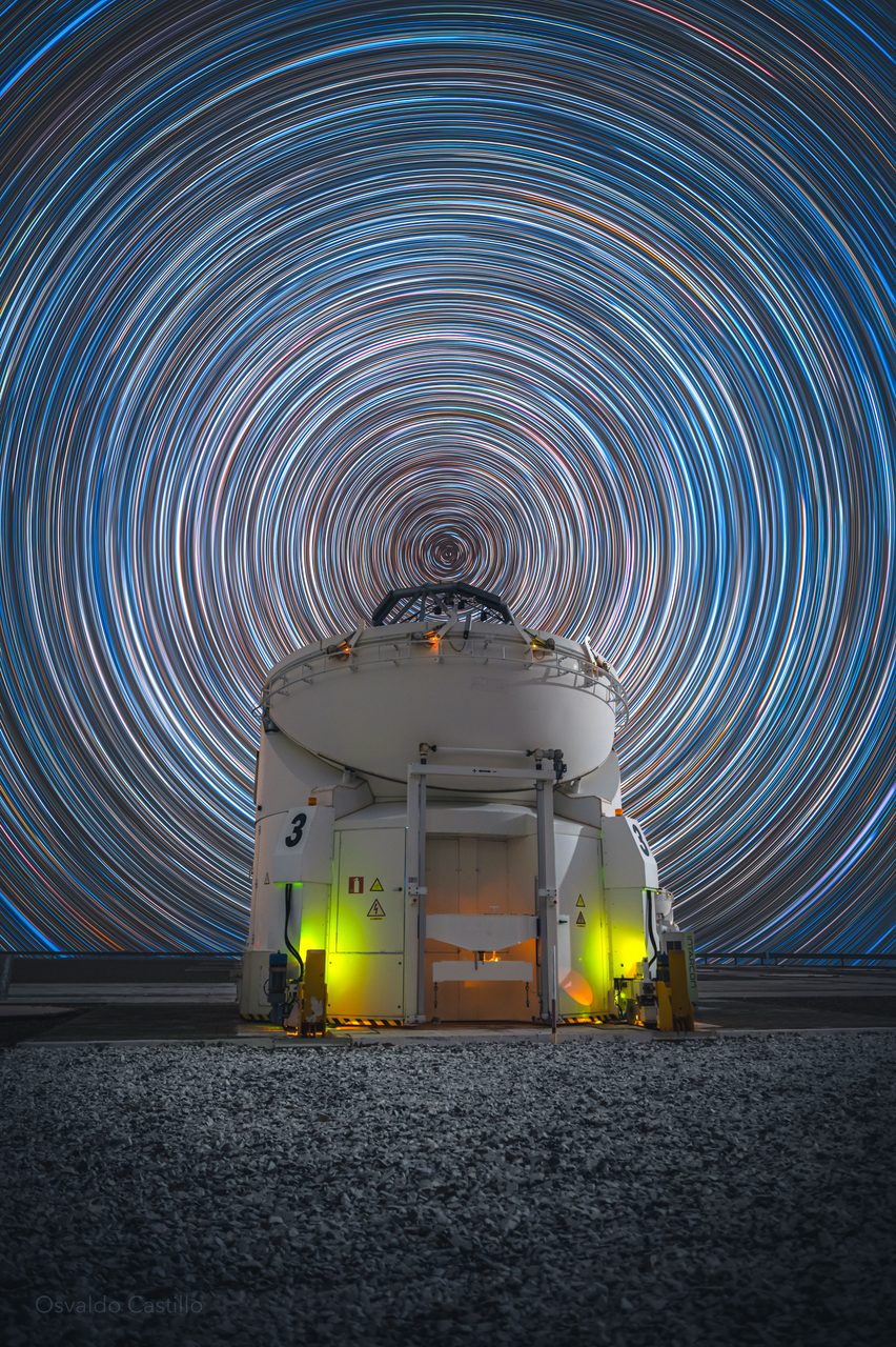 Star trails create circular patterns in the night sky over the Paranal Observatory in Chile.