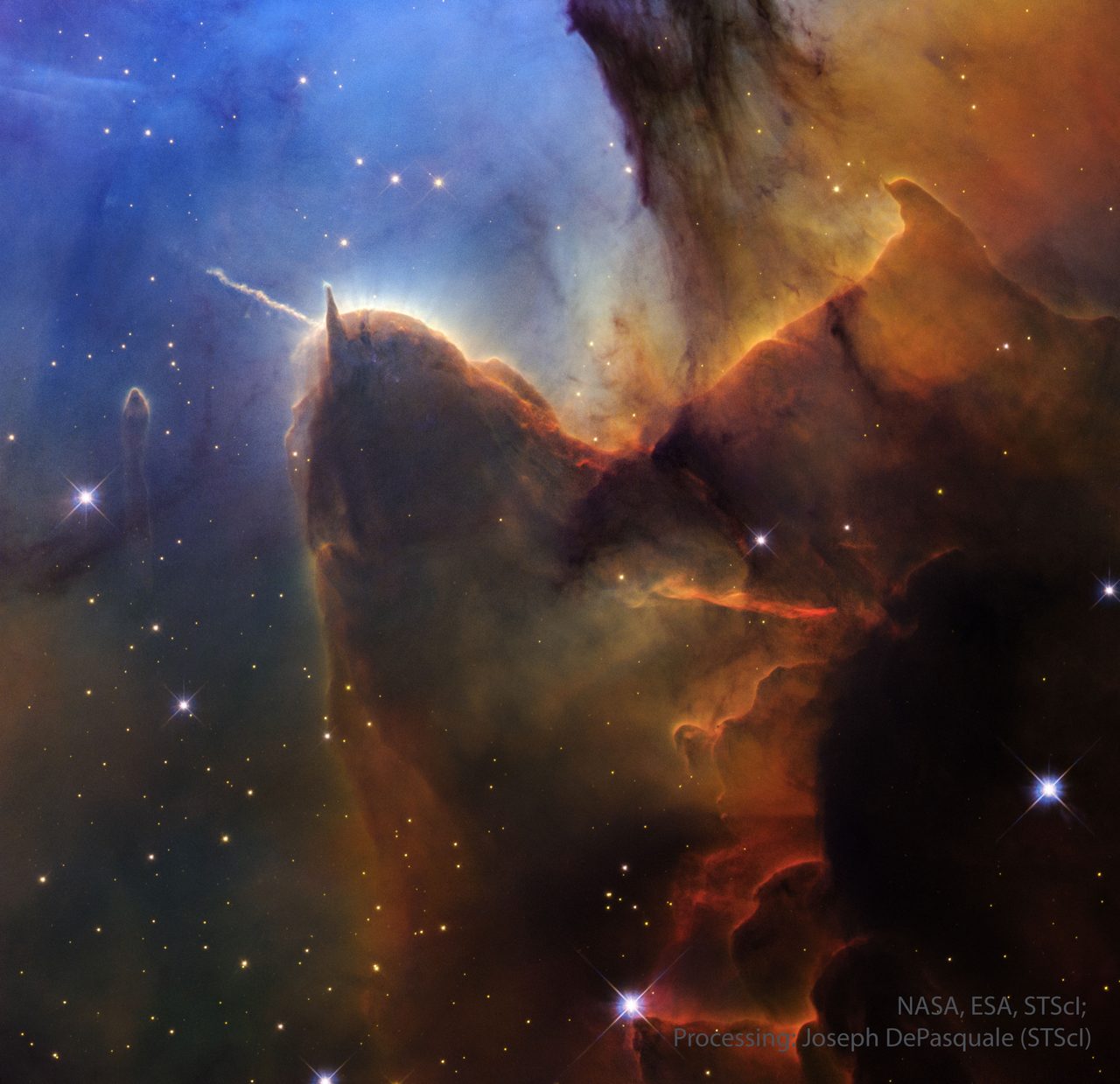 A vibrant cosmic scene showing the Trifid Nebula's colorful pillars and jets against a starry background.
