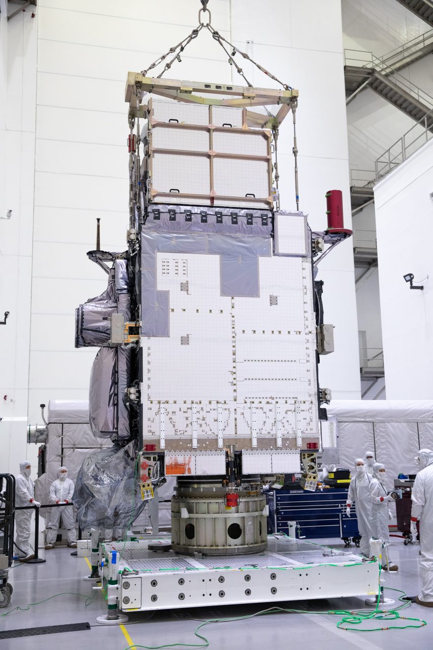 GOES-U satellite being unboxed, lifted to vertical position, and moved to a support stand.