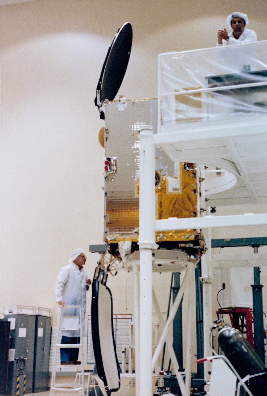 INSAT satellite payload being loaded into the space shuttle cargo bay for launch.