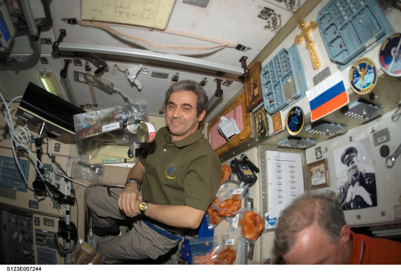 Astronaut Eyharts operating equipment inside the space module during joint mission operations