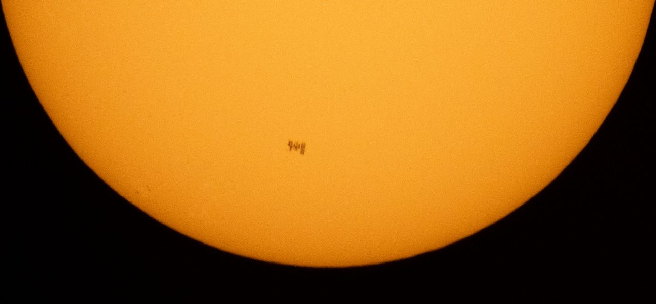 The International Space Station silhouetted against the sun during a solar transit.