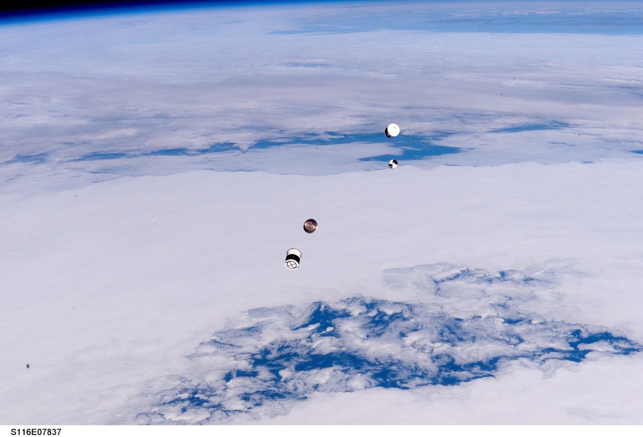 DOD Pico-Satellite ANDE being deployed from STS-116 shuttle's payload bay into space.