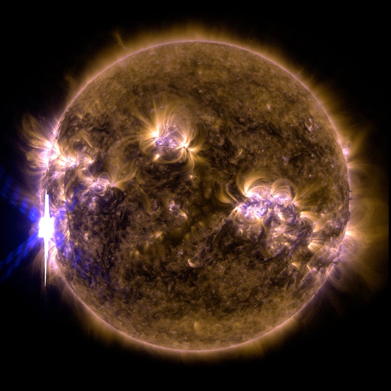 A vibrant solar flare erupts from the sun's surface, captured by NASA's Solar Dynamics Observatory.