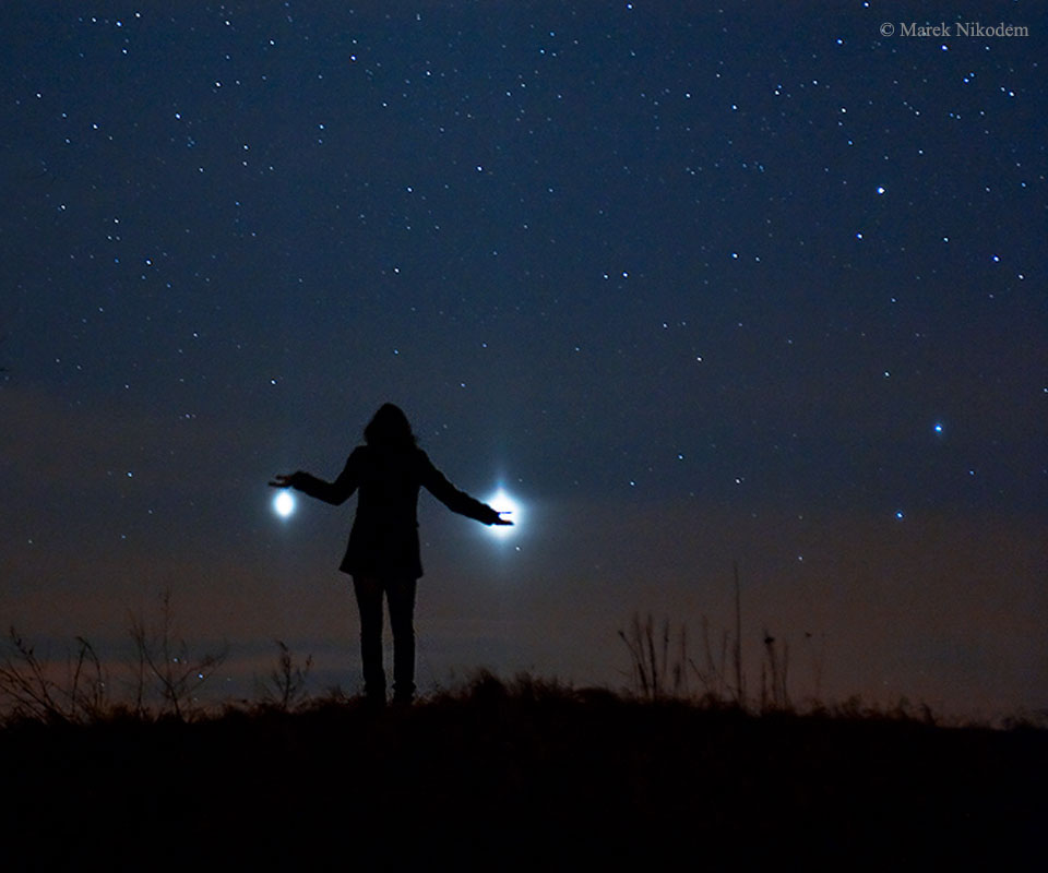 Bright Jupiter and Venus visible in the night sky, surrounded by twinkling stars, as seen from Earth.