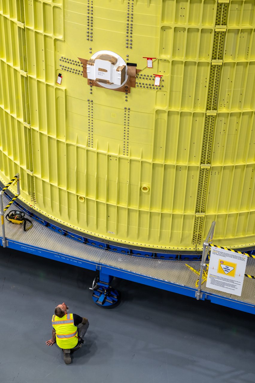 Technicians maneuver the intertank of NASA's Space Launch System rocket at Michoud Assembly Facility.