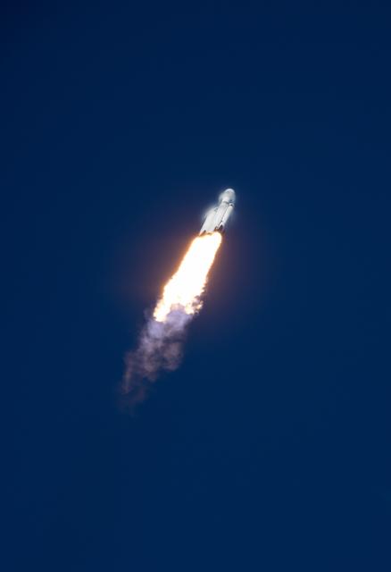 NASA's SpaceX GOES-U rocket launches into a clear sky, leaving a trail of smoke behind.