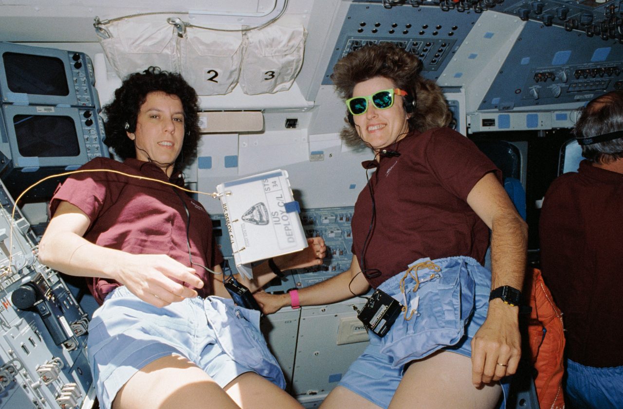 STS-34 astronauts conducting pre-deployment exercises for Galileo mission on the shuttle's flight deck.