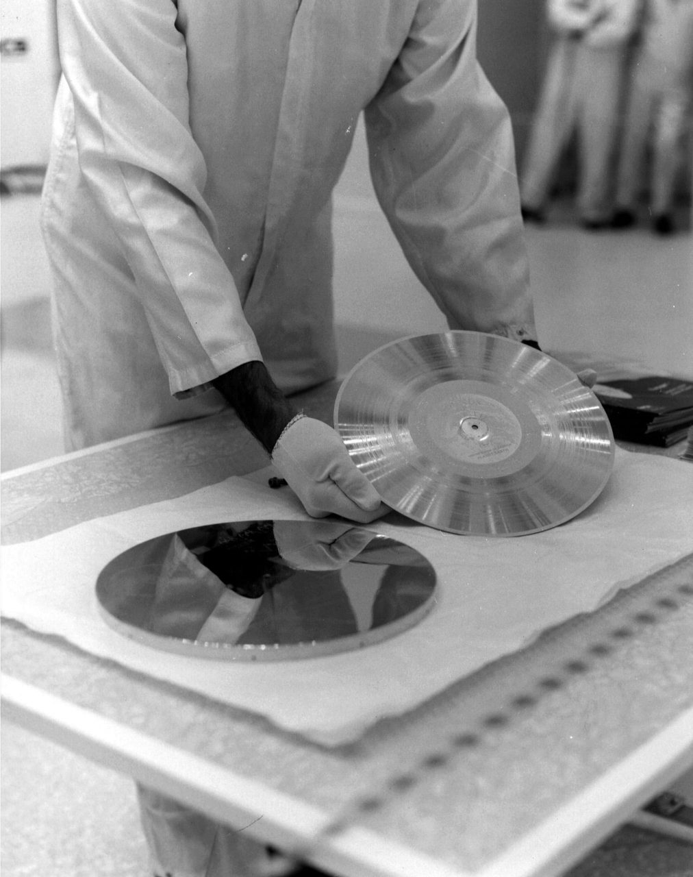 Technicians prepare NASA's Voyager 1 Golden Record for installation on the spacecraft.