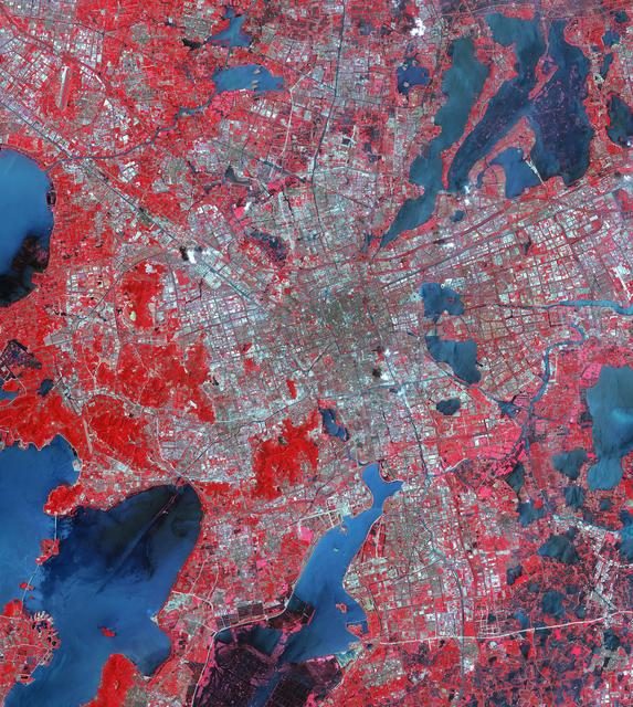 Aerial view of Suzhou, Jiangsu, China, showing urban landscape and waterways, captured by NASA's Terra spacecraft.