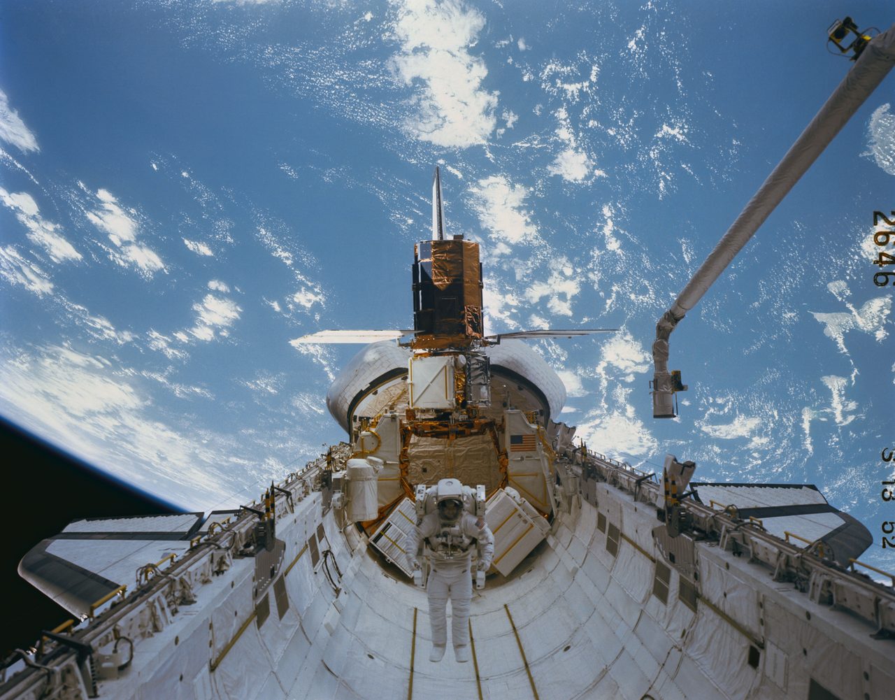 Astronaut repairs Solar Maximum Mission Satellite during Space Shuttle mission 41-C in orbit.