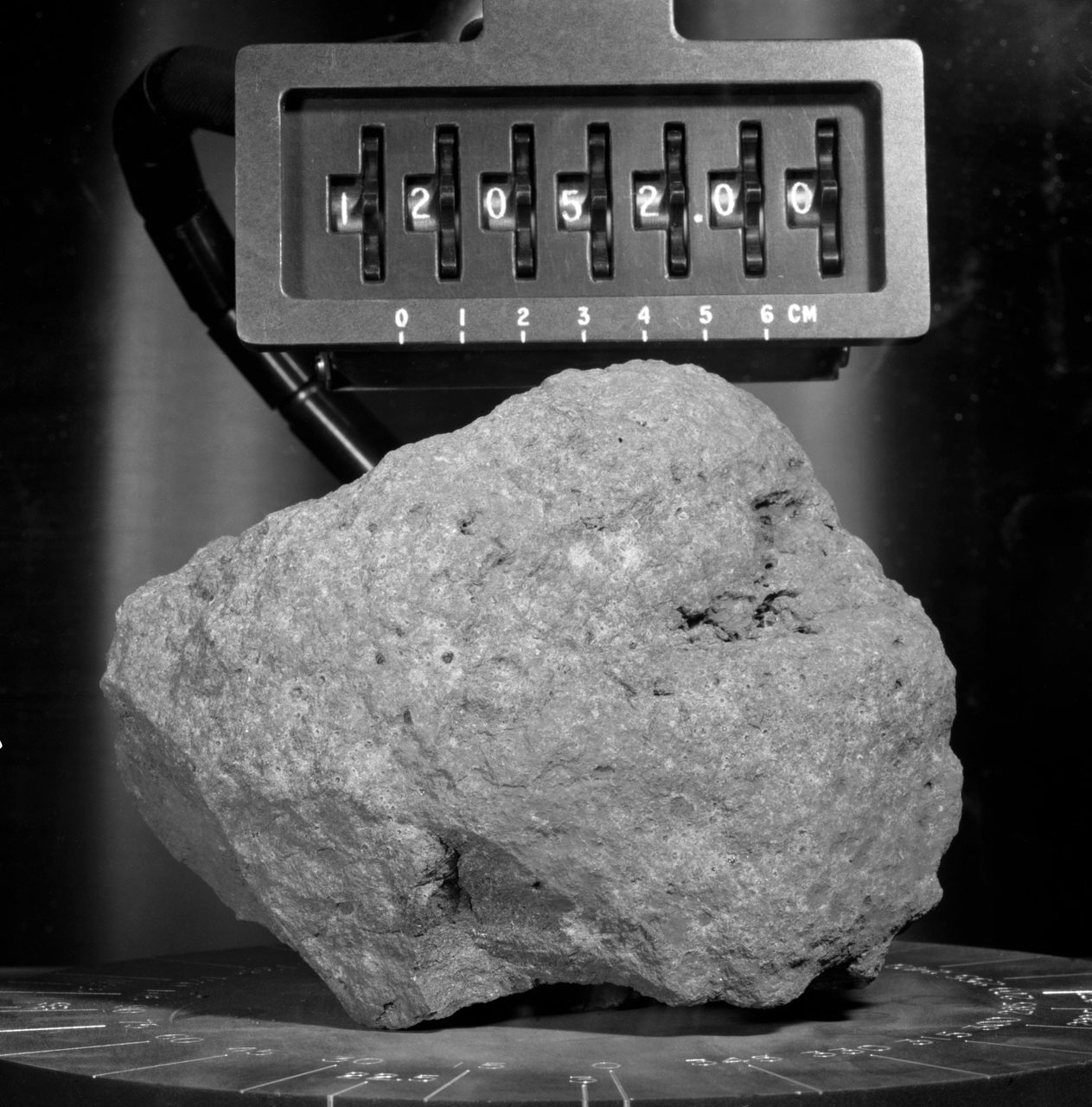 Close-up photo of a lunar rock sample collected during Apollo 12 mission, showcasing its texture and composition.