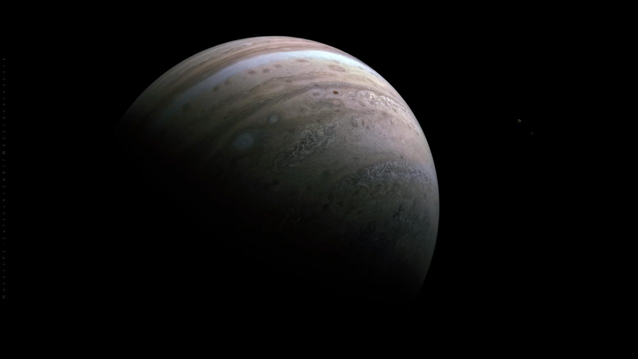Juno spacecraft captures Jupiter's southern hemisphere with moons Io and Europa during close flyby.