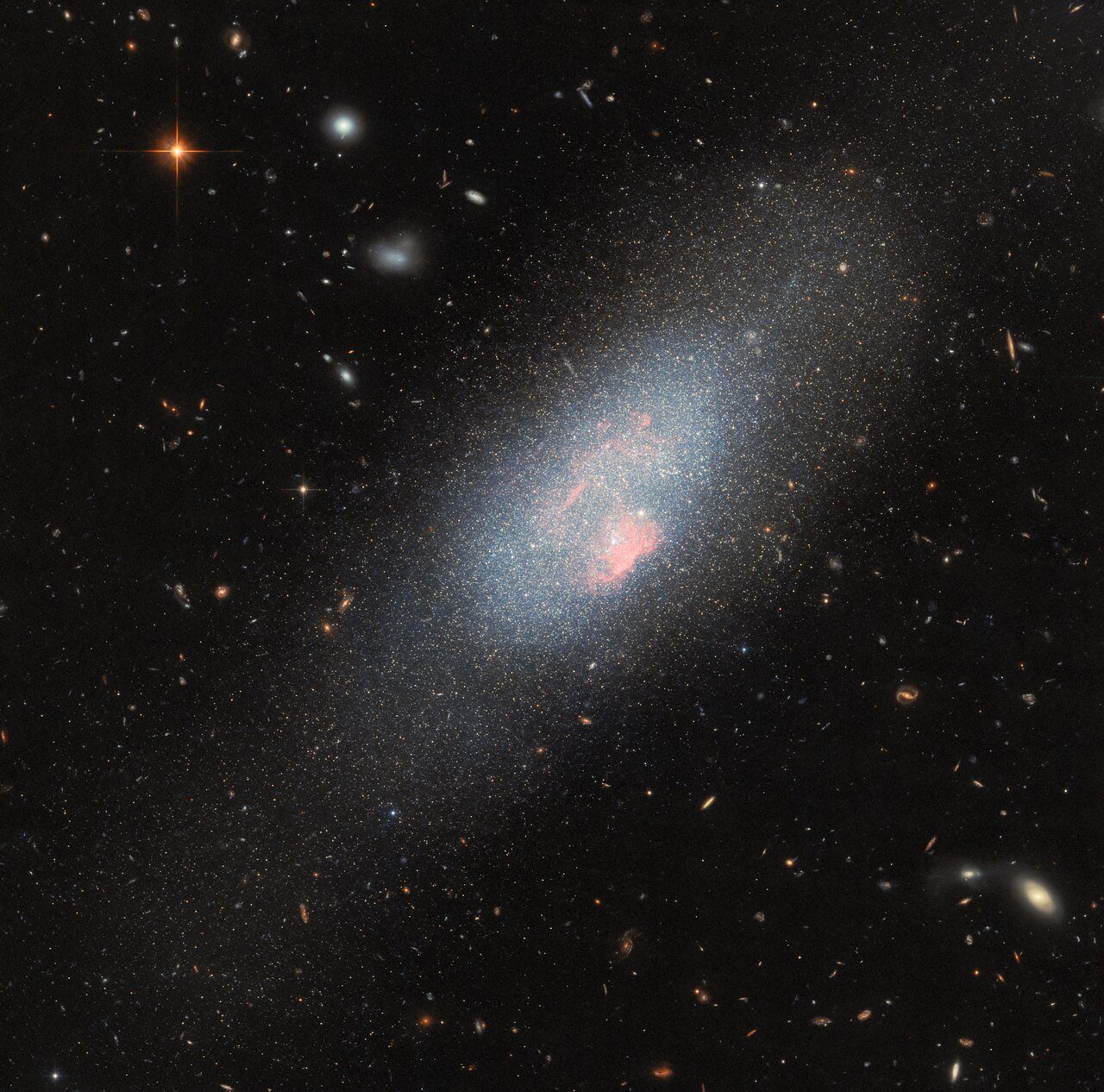 A cluster of massive stars illuminating the surrounding space with vibrant colors and patterns.