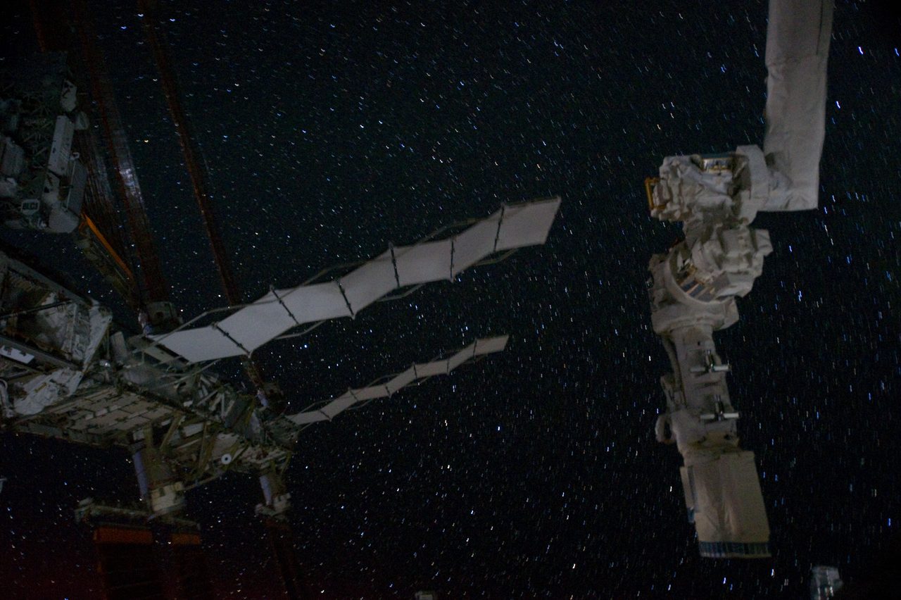 Partial view of the International Space Station with a starry night sky backdrop