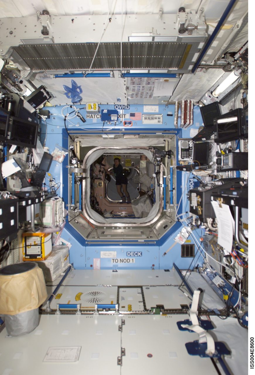 Expedition Four captures detailed interior view of U.S. Laboratory, showcasing scientific equipment and workspace layout.