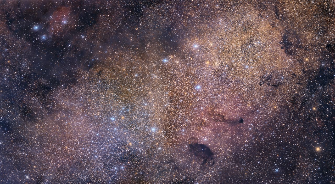 A dense star field of Messier 24 in the Sagittarius constellation, showcasing a vibrant array of stars and cosmic dust.