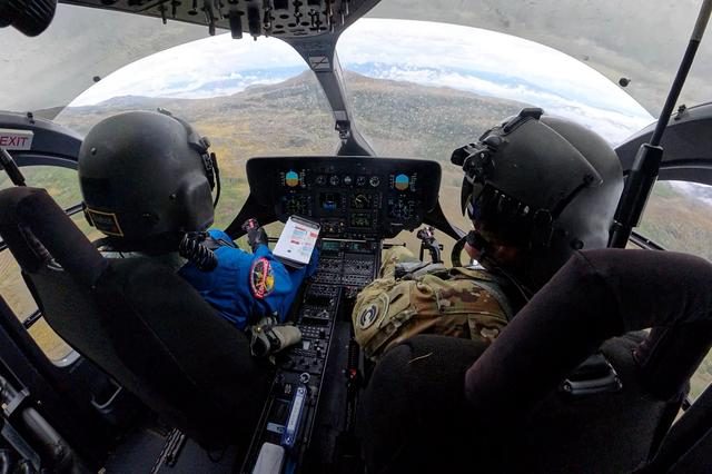 Helicopter flying over Colorado mountains for NASA's Artemis Moon landing training course.