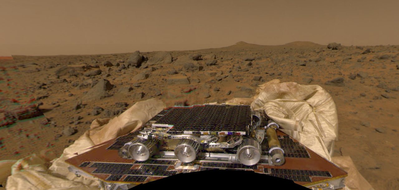 NASA's Pathfinder rover exploring the rocky Martian surface under a clear sky.