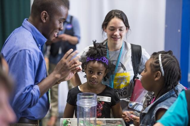 Crowds explore interactive exhibits at the 2014 USA Science and Engineering Festival, promoting STEM education.