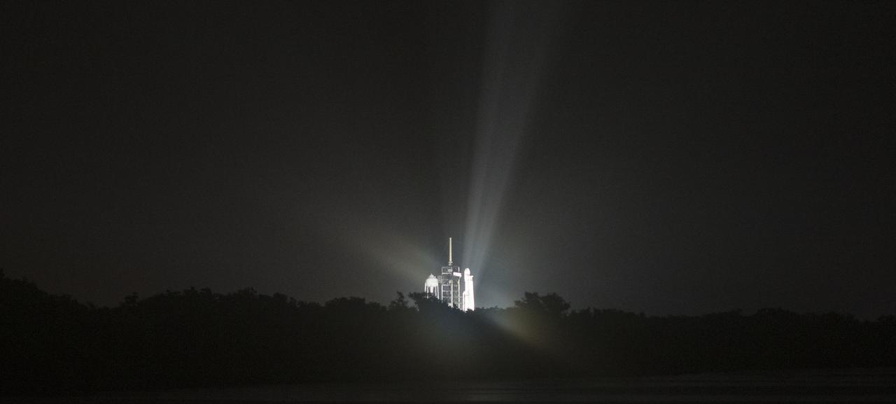 Falcon Heavy illuminated on the pad at Kennedy Space Center